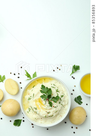 Plate of mashed potatoes and ingredients on white background 85356893