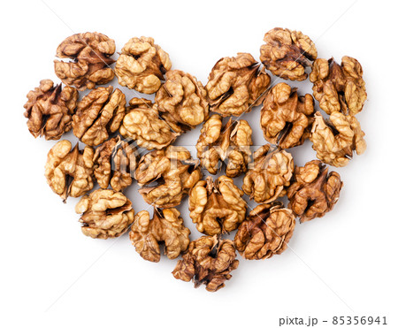 Walnuts kernels lined with hearts on a white background. Top view Walnuts kernels lined with hearts on a white background. Top view 85356941