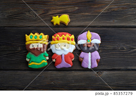Happy Epiiphany day. Homemade cookies in the shape of the three wise men on wooden background. 85357279