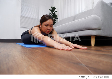 Young Asian women practicing yoga, exercise, stretching in the living room. Young Asian women practicing yoga, exercise, stretching in the living room. 85358166