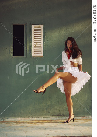 Dancing Woman in Elegant Summer Outfit Outdoors Against House Background 85358179
