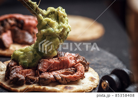Process of cooking tacos with grilled flank beef steak with handmade guacomole Process of cooking tacos with grilled flank beef steak with handmade guacomole 85358408