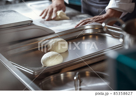 Making dough for bread by male hands in restaurant kitchen. Cooking concept. Making dough for bread by male hands in restaurant kitchen. Cooking concept. 85358627