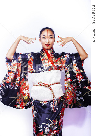 young pretty geisha in black kimono posing isolated on white background, asian ethno young pretty geisha in black kimono posing isolated on white background, asian ethno 85359952
