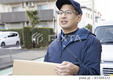 荷物を届ける宅配便の男性 85368322