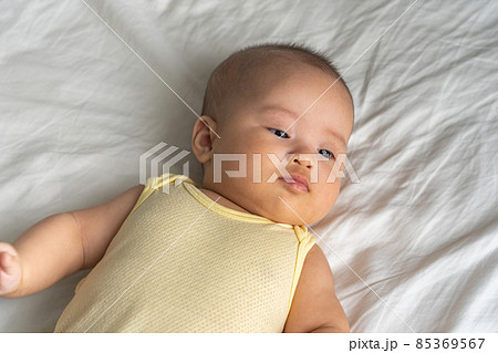 Adorable Asian baby girl on the white bed background 85369567