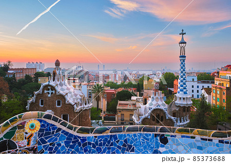 Barcelona city view from Guell Park. Sunrise view of colorful mosaic building in Park Guell Barcelona city view from Guell Park. Sunrise view of colorful mosaic building in Park Guell 85373688