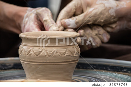 Master class on modeling of clay on a potter's wheel In the pottery workshop 85373743