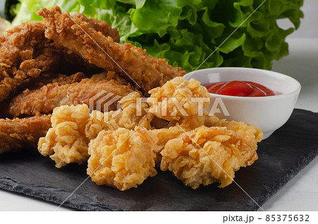 Fried chicken with french fries and nuggets. 85375632
