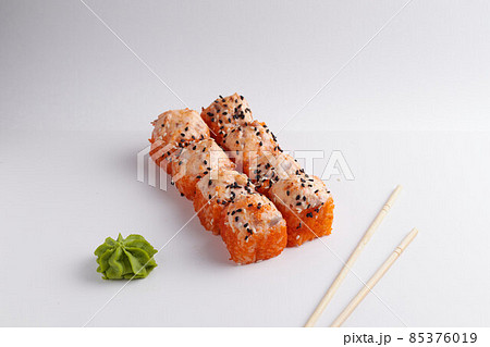 a portion of rolls on a stand, japanese food, sushi on the table, chinese chopsticks, light background 85376019