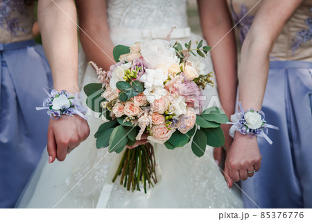 Bouquet of flowers in the hands of the girls Bouquet of flowers in the hands of the girls 85376776