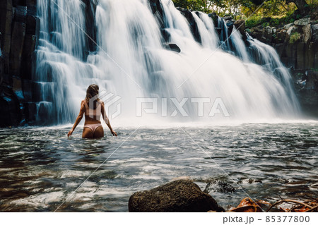 Rochester Falls and woman in bikini. Amazing cascade waterfall at Mauritius 85377800