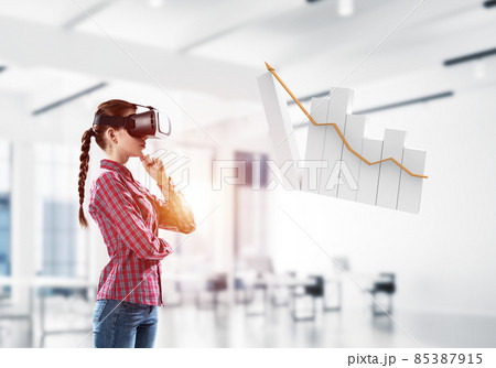 Girl in virtual reality mask experiencing virtual technology world. Mixed media Girl in virtual reality mask experiencing virtual technology world. Mixed media 85387915