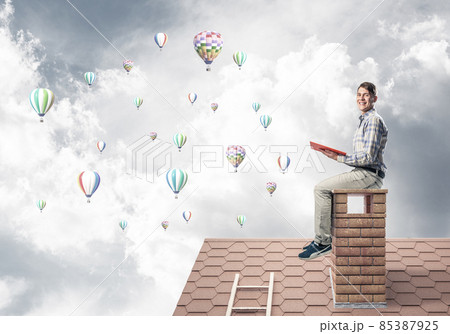 Handsome student guy reading book and aerostats flying in air 85387925