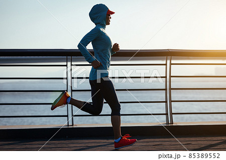 Fitness woman runner running on seaside bridge 85389552