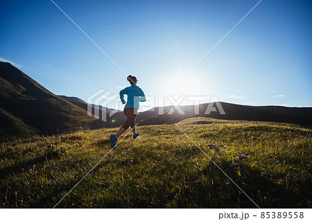 Woman ultramarathon runner running at mountain top 85389558
