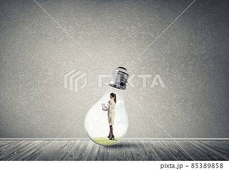 Businesswoman trapped in bulb Businesswoman trapped in bulb 85389858