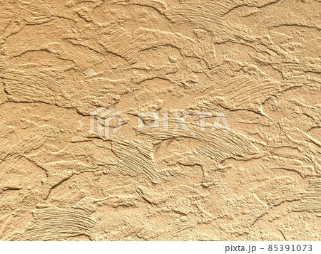 でこぼこなベージュの壁、背景素材 85391073