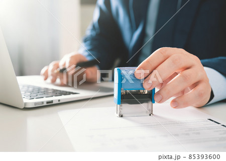 Businessman working in office with stamp 85393600