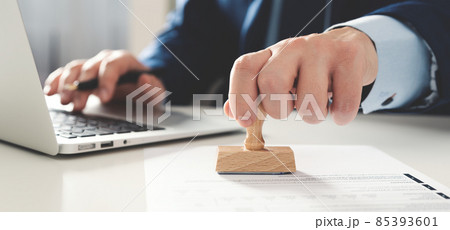 Businessman working in office with stamp 85393601