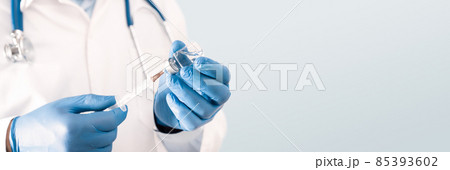 Doctor holding a vial with a vaccine 85393602