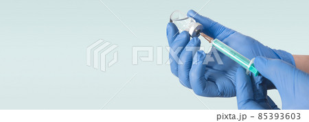Doctor holding a vial with a vaccine Doctor holding a vial with a vaccine 85393603