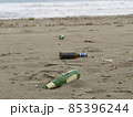 trash on the beach: beer bottles abandoned on the sand 85396244