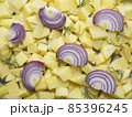 chopped raw potatoes with red onion slices and rosemary leaves 85396245
