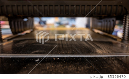 Selective focus looking into a wood planer bed raised above the board Selective focus looking into a wood planer bed raised above the board 85396470