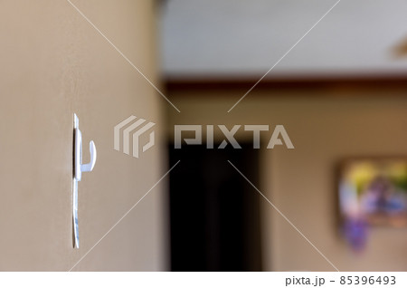Selective focus on adhesive strip wall hanger that can be removed by pulling tape Selective focus on adhesive strip wall hanger that can be removed by pulling tape 85396493