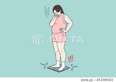 Unhappy obese woman shocked by weight on scales  85396583