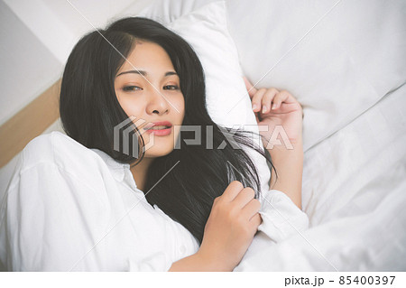 young woman sleeping on bed in bedroom at home young woman sleeping on bed in bedroom at home 85400397