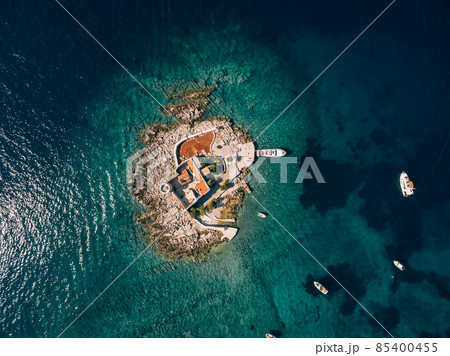 Boats stand near the island of Otocic Gospa. Montenegro. Drone 85400455