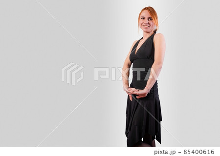 Girl in a black evening dress dress, on a gray background 85400616