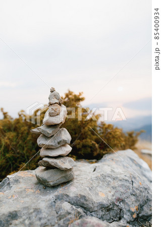 Pyramid of stones on a large stone at the top of a mountain Pyramid of stones on a large stone at the top of a mountain 85400934