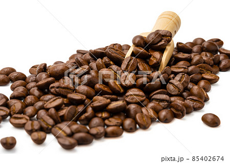 Pile of roasted coffee beans with wooden scoop on white background, selective focus. Pile of roasted coffee beans with wooden scoop on white background, selective focus. 85402674