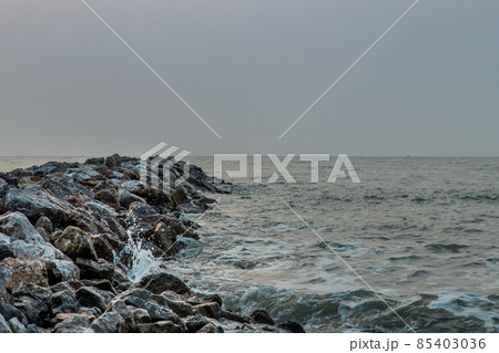 View of sea waves hitting rocks on the Calm beach in the morning. View of sea waves hitting rocks on the Calm beach in the morning. 85403036