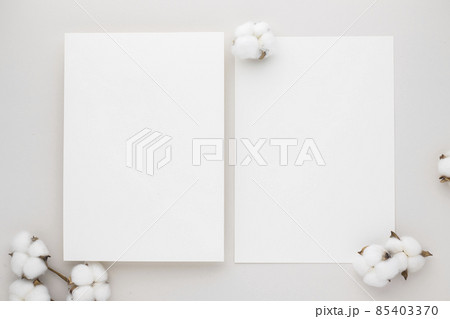 White invitation card mockup with a cotton flower on beige background, Minimal beige workplace composition, flat lay, mockup White invitation card mockup with a cotton flower on beige background, Minimal beige workplace composition, flat lay, mockup 85403370