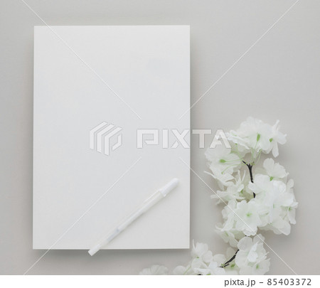 White invitation card mockup with a white flower on beige background, Minimal beige workplace composition, flat lay, mockup White invitation card mockup with a white flower on beige background, Minimal beige workplace composition, flat lay, mockup 85403372