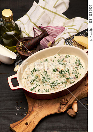 Delicious meatballs with spinach in a creamy sauce in baking dish 85403634