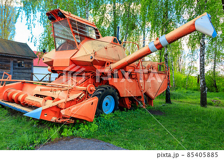 Old combine harvester in the farmyard. Old agricultural machinery 85405885