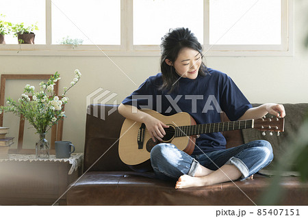 ギターを持った若い女性 85407151
