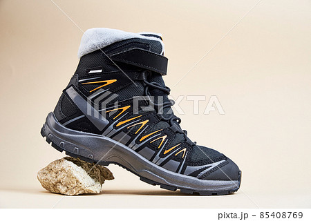 Male winter shoes on beige background Male winter shoes on beige background 85408769