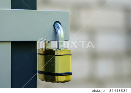 locked padlock with yellow body hangs in the door loop locked padlock with yellow body hangs in the door loop 85413385