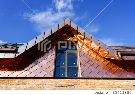 a fragment of a house facade lined with copper plates 85413386