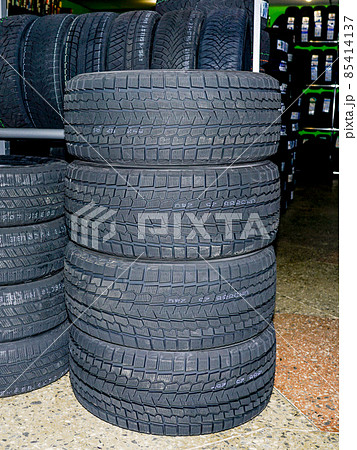 a set of new soft tread winter tires in a tire store a set of new soft tread winter tires in a tire store 85414137