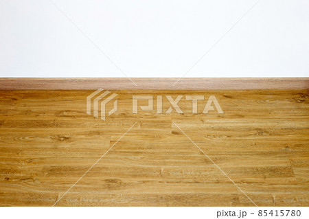 Laminate wood floor with blank white wall 85415780