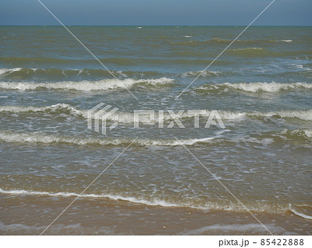 Ocean wave with white bubbles, Green sea water and Nautical landscape background. Seaside horizon view, Waves and the beach Ocean wave with white bubbles, Green sea water and Nautical landscape background. Seaside horizon view, Waves and the beach 85422888