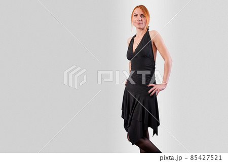 Girl in a black evening dress, on a gray background Girl in a black evening dress, on a gray background 85427521
