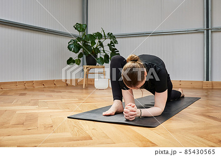 crouched woman with no recognizable face practicing yoga crouched woman with no recognizable face practicing yoga 85430565